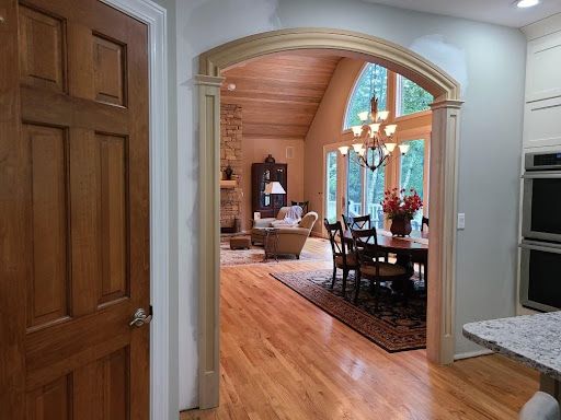 A doorway leading to a living room and dining room in a house.