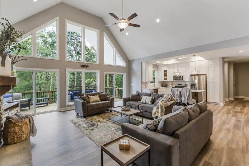 A living room with a lot of furniture and a ceiling fan