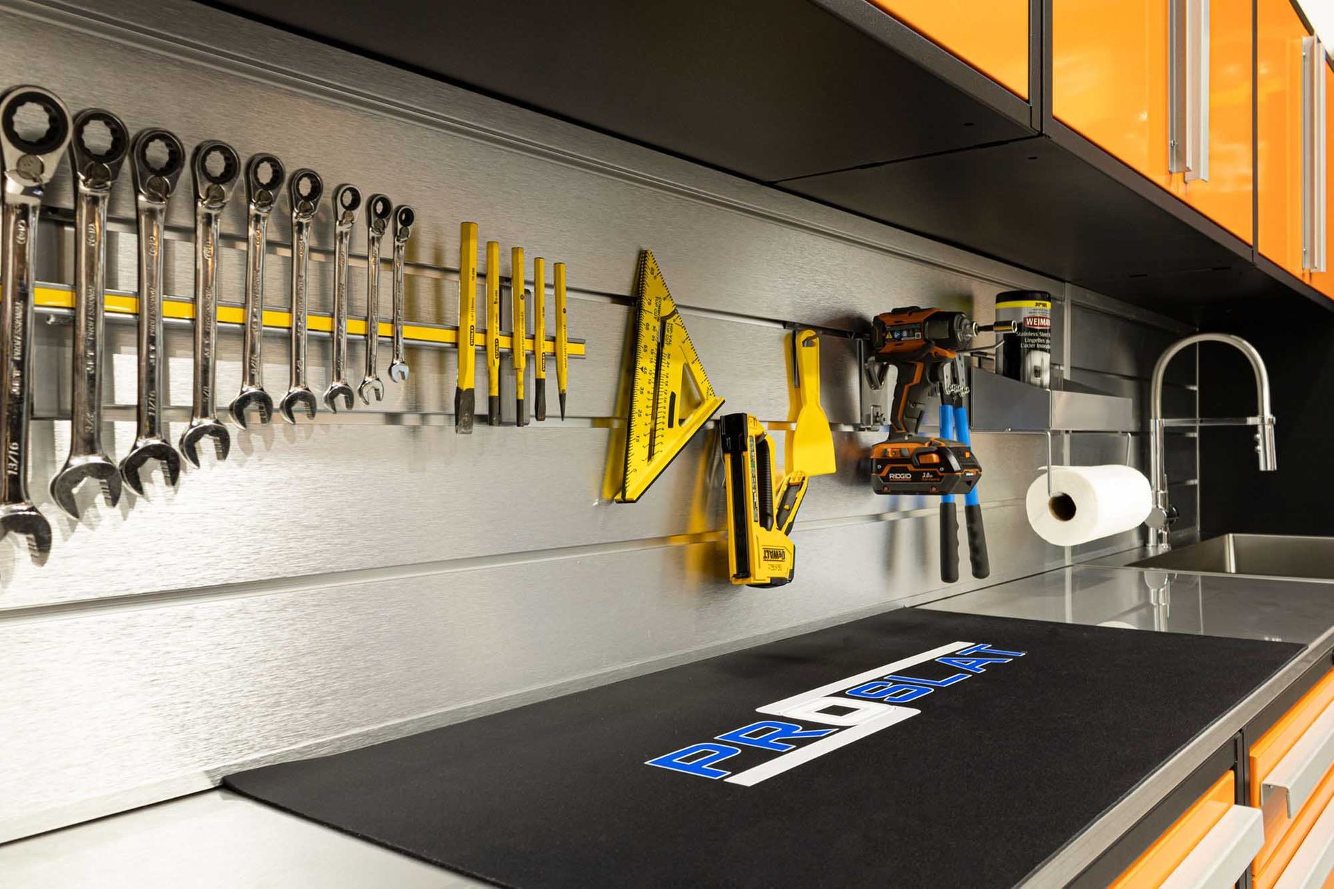Workshop with tools organized on a wall. Includes wrenches, drills, and a sink.