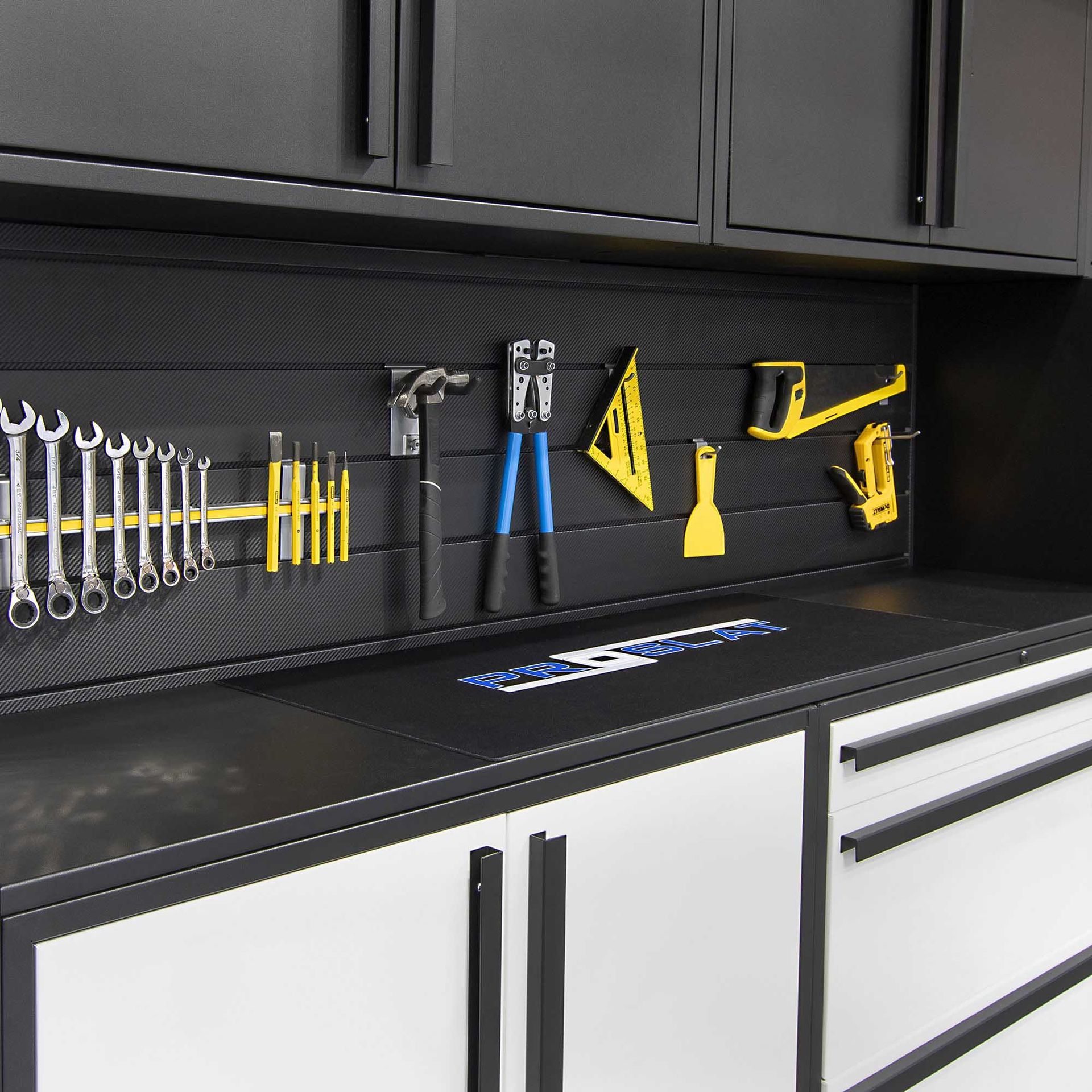 Garage workspace with tools, cabinets, and a black and white color scheme.