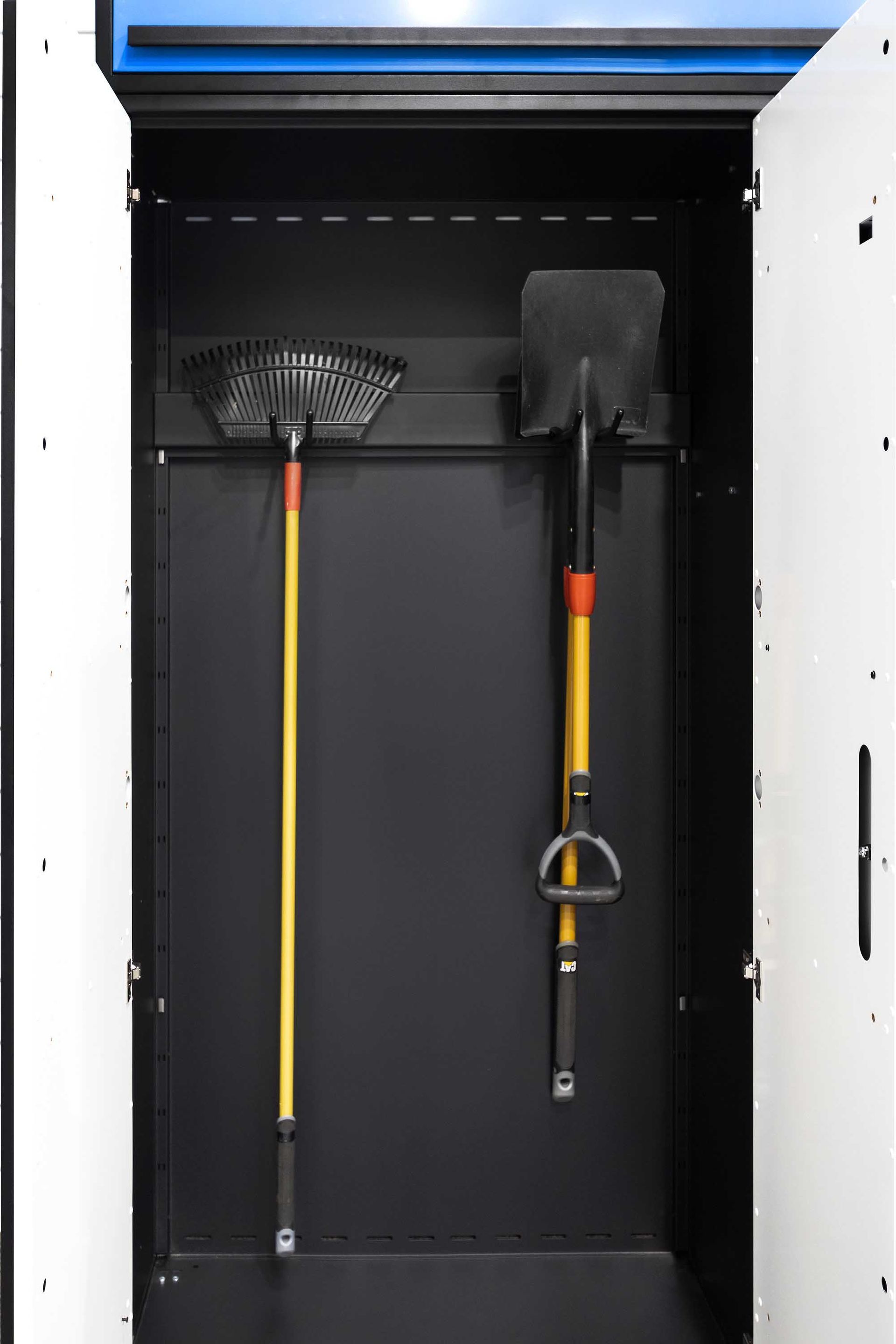 Black cabinet with a rake and shovel hanging inside.