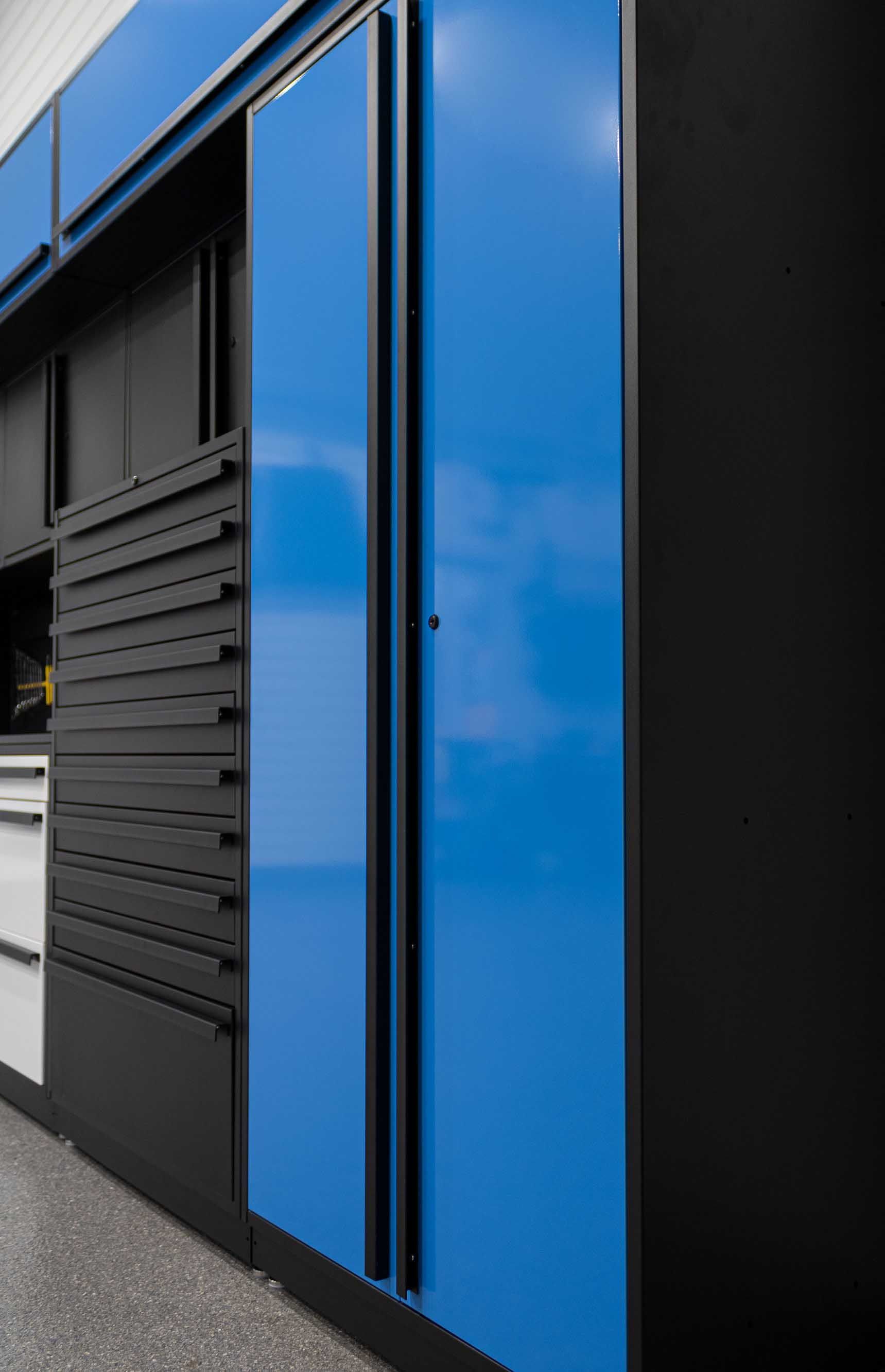 Blue and black storage unit with sliding doors; exterior setting.