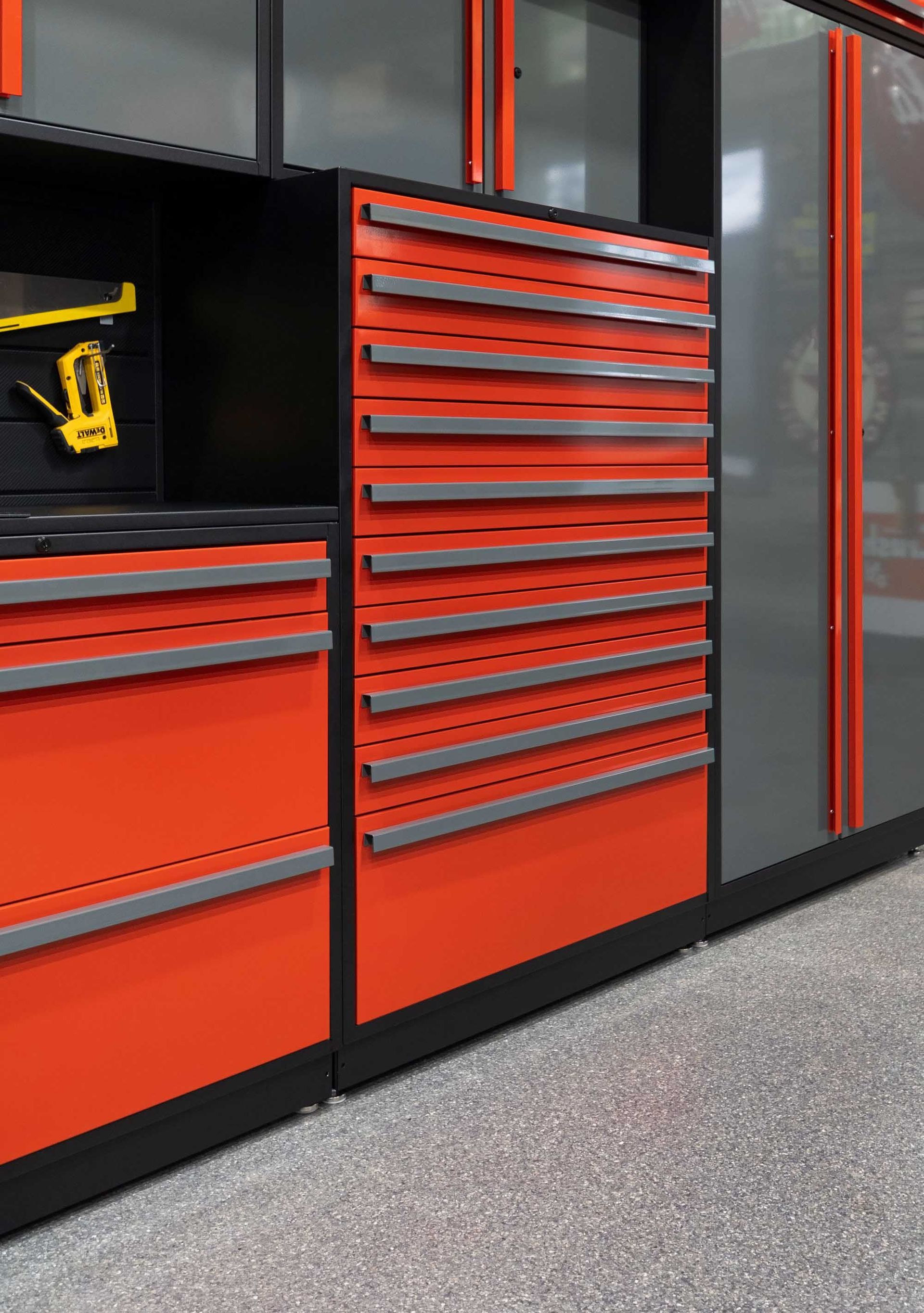 Red and black garage cabinets with multiple drawers and gray trim.