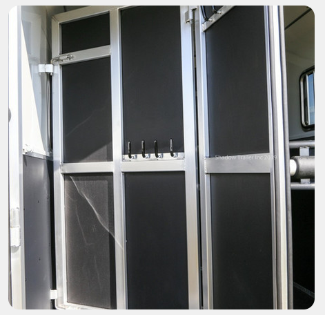 A close up of a door with hooks on it