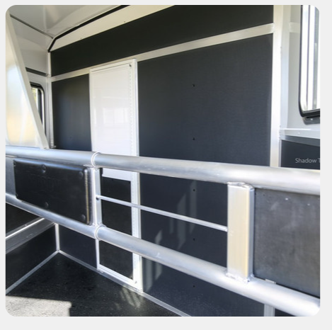 A black and white room with a railing and a door