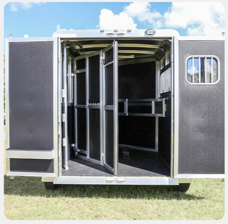 A horse trailer with the doors open and a window