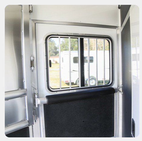 A white door with a window and bars on it