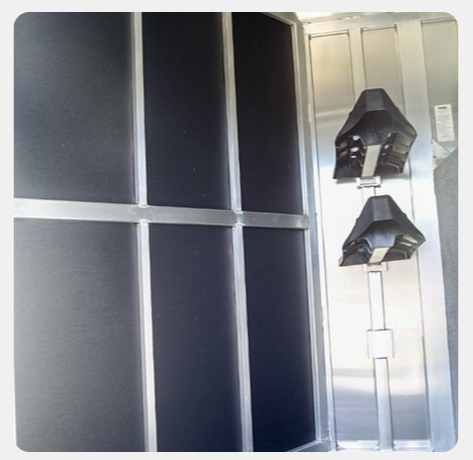 A stainless steel elevator with a black wall