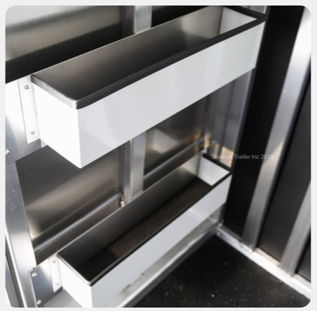 A picture of a stainless steel cabinet with white drawers