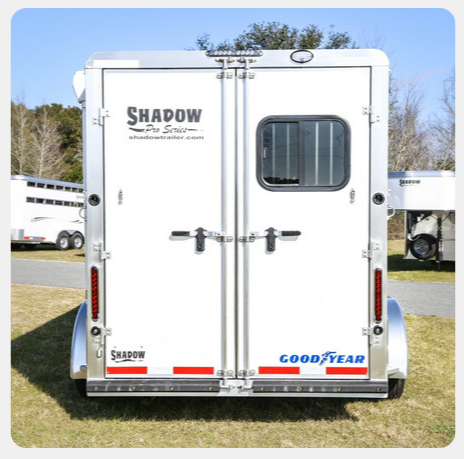 A white trailer with the word shadow on it