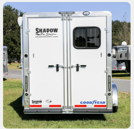A white trailer with the word shadow on it