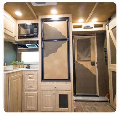 A kitchen with a refrigerator and a microwave