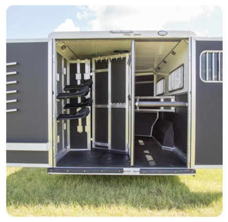 The inside of a horse trailer with the door open