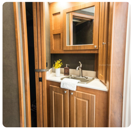 A bathroom with wooden cabinets and a sink