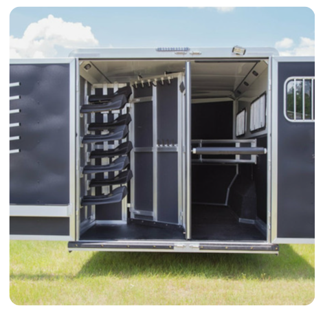 The inside of a horse trailer with the doors open