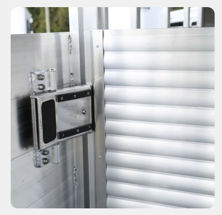 A close up of a stainless steel door with a black handle