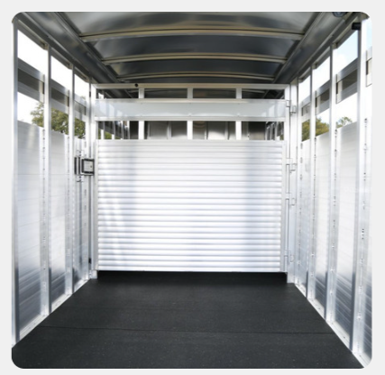 The inside of a trailer with a roller door