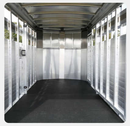 An empty trailer with a black mat on the floor