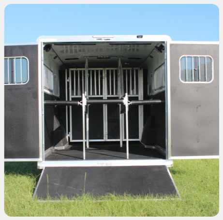 The inside of a horse trailer with the doors open