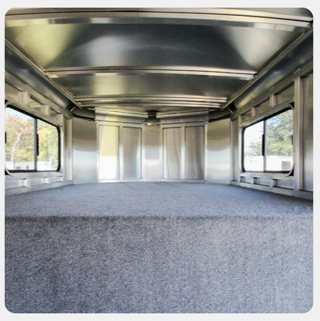 The inside of a trailer with a carpeted floor