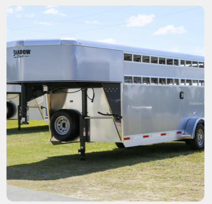 A horse trailer with the word shadow on the side