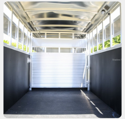 The inside of a trailer with a white door