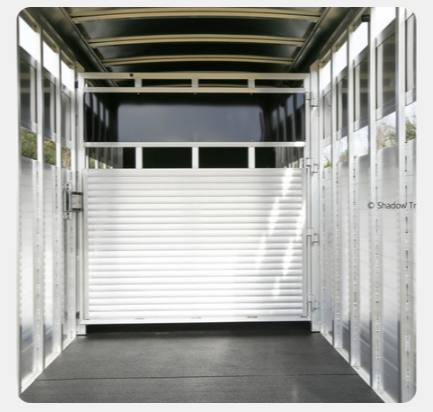 The inside of a trailer with a white door
