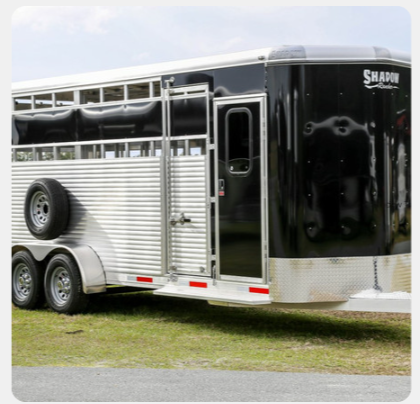 A shaun trailer is parked in the grass