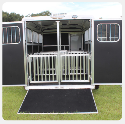 The back of a horse trailer with the doors open