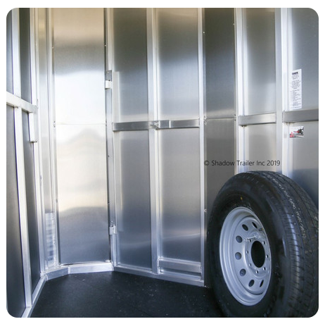 A picture of the inside of a trailer with a tire
