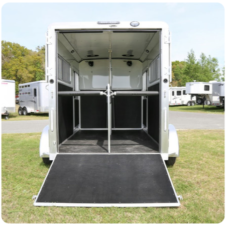 The back of a horse trailer with the door open
