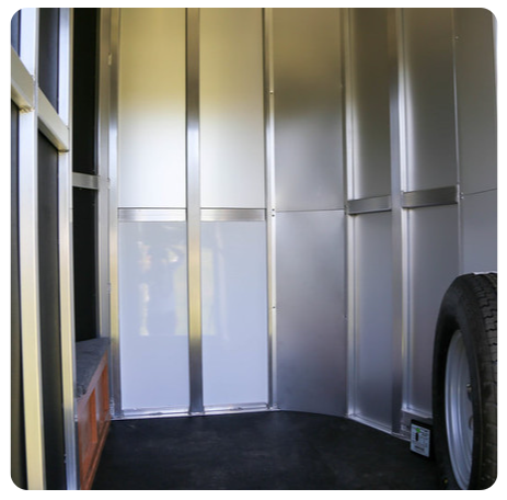 The inside of a trailer with a tire on the floor