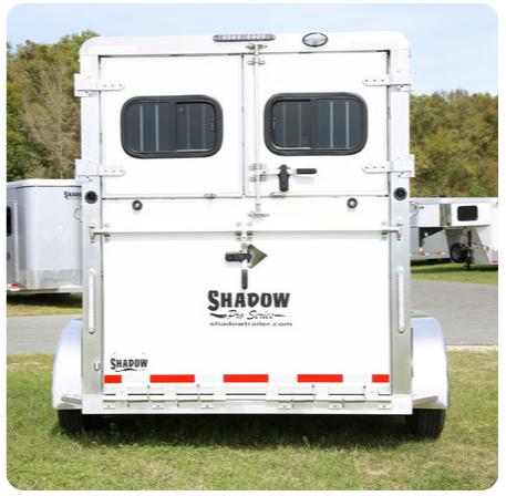 The back of a white trailer with shadow written on it