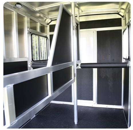The inside of a horse trailer with black walls