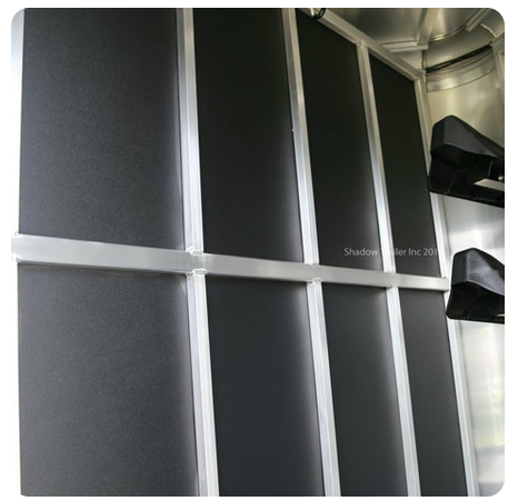 A close up of a black wall with a silver frame