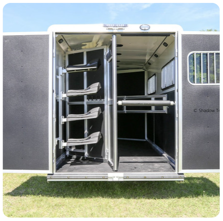 The back of a horse trailer with the door open
