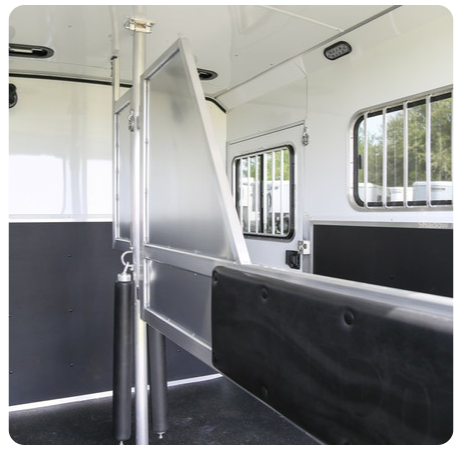 The inside of a horse trailer with the door open