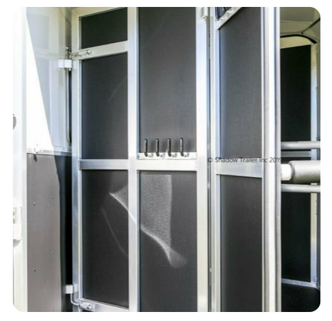 A close up of a door with hooks on it