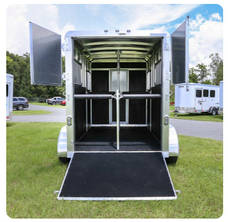 The inside of a horse trailer with the doors open