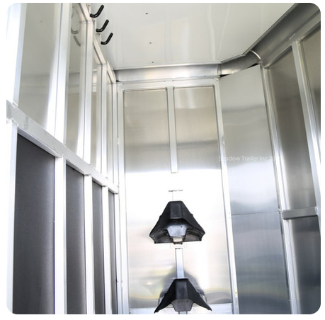 A stainless steel room with hooks on the ceiling