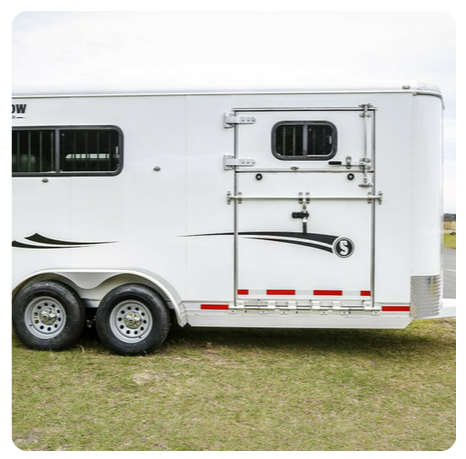 A white horse trailer with the number 9 on the side