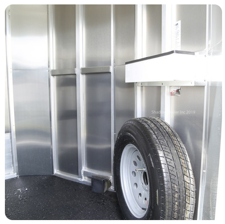 A tire is attached to the side of a trailer