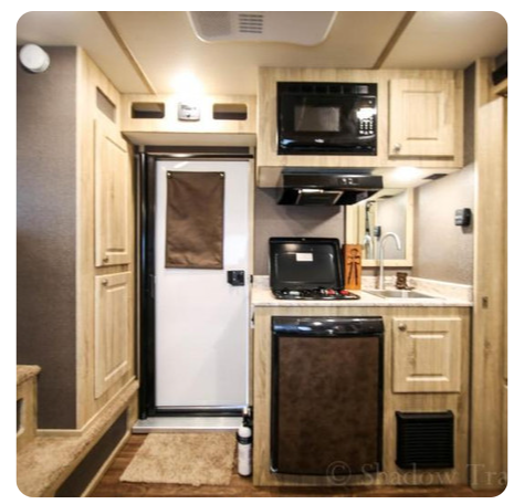 A small kitchen with a microwave and a refrigerator