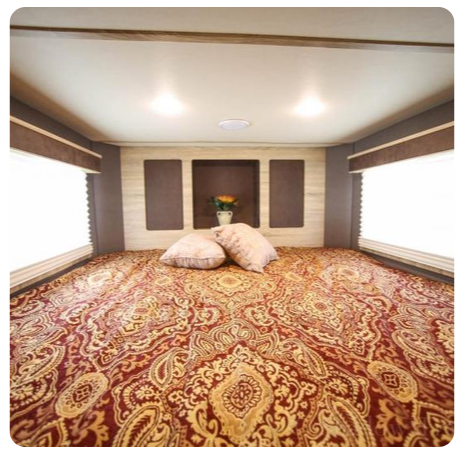 A bedroom with a bed and pillows on it