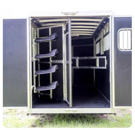 The inside of a horse trailer with the doors open