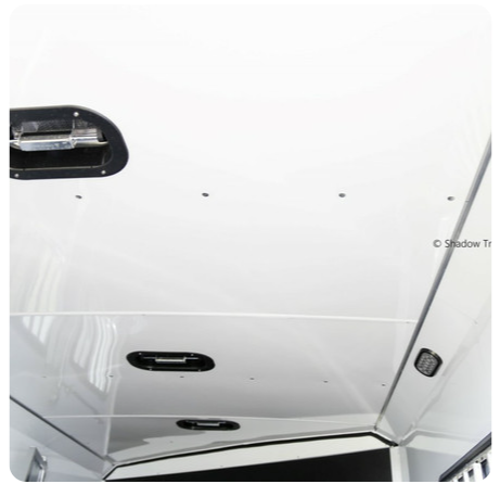 A white ceiling with a black handle on it