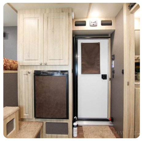 A picture of a kitchen with a door and cabinets