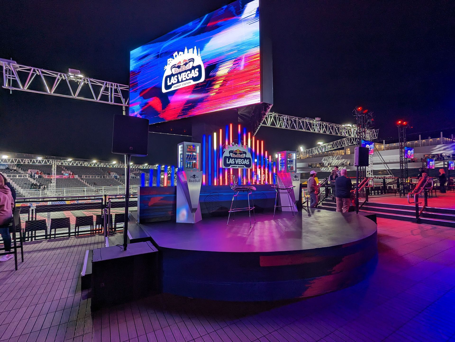 Stage with a large screen displaying Las Vegas logo at night.