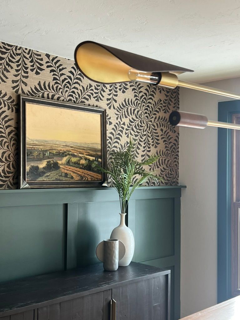 There is a picture on the wall above the dresser.