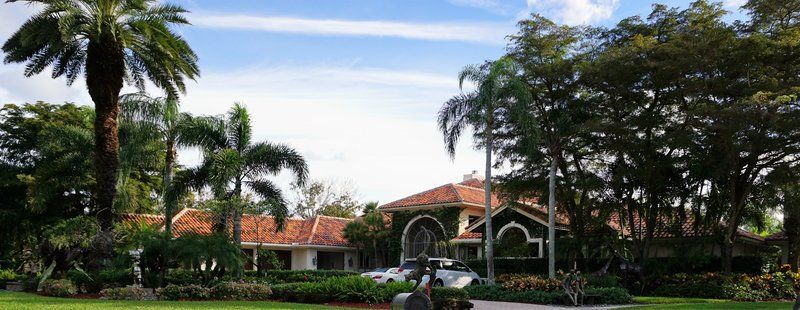 A large house with a lot of trees in front of it.